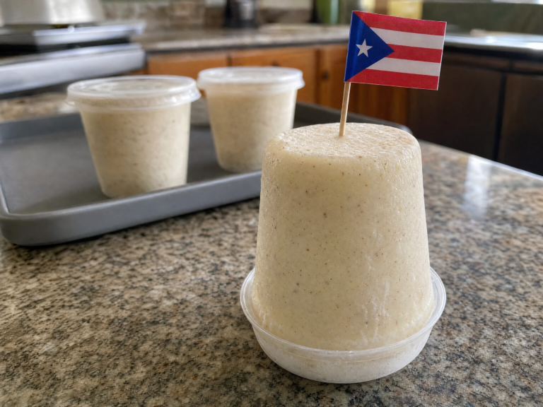 Puerto Rican limber de coco flipped inside a clear cup with a creamy coconut texture and small cinnamon specks