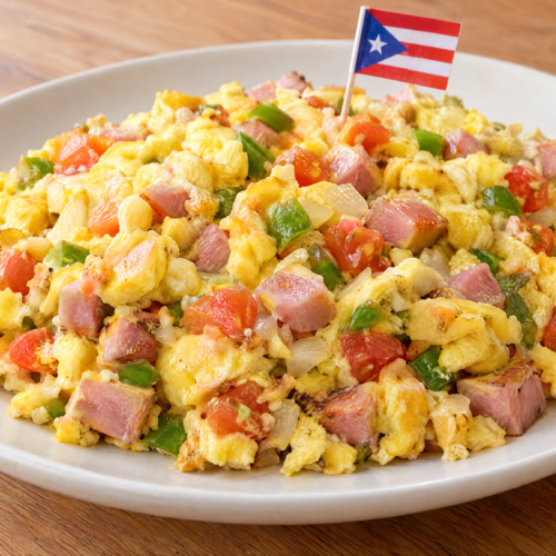 Puerto Rican revoltillo con jamón with fluffy scrambled eggs, diced ham, green pepper, onion, and tomato