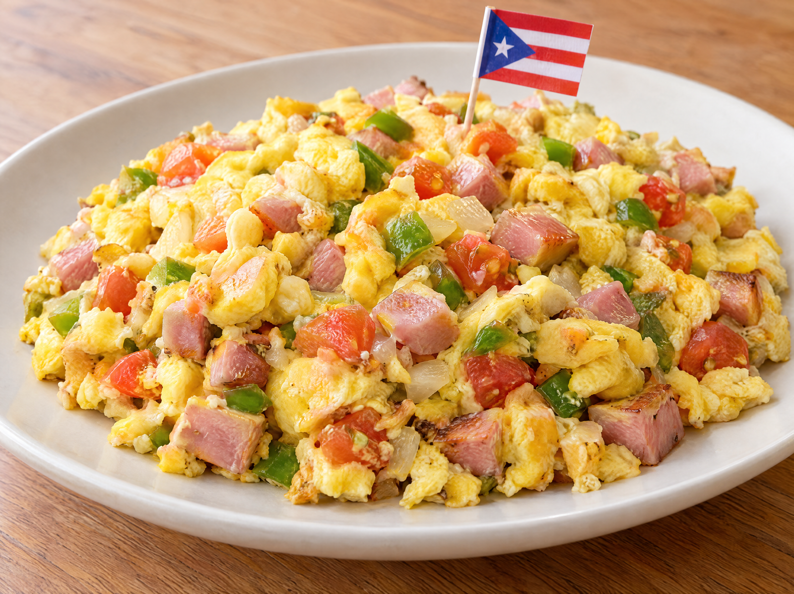 Puerto Rican revoltillo con jamón with fluffy scrambled eggs, diced ham, green pepper, onion, and tomato